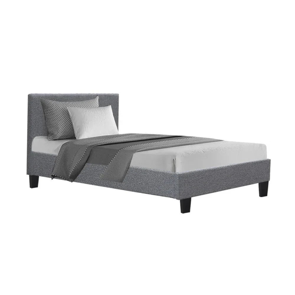Grey fabric King Single bed frame with padded headboard in modern minimalist bedroom setting.