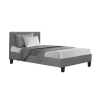 Grey fabric King Single bed frame with padded headboard in modern minimalist bedroom setting.
