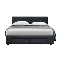 Side view of charcoal fabric double bed frame with under-bed storage drawers slightly opened.