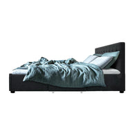 Under-bed wooden slat base providing mattress support on charcoal fabric bed frame.