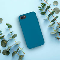 Biodegradable phone case in Deep Blue Ocean color displayed against soft background.