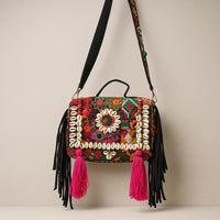 Colorful Banjara Boho Sling Bag with pink tassels and vibrant mirror and sequin embroidery.