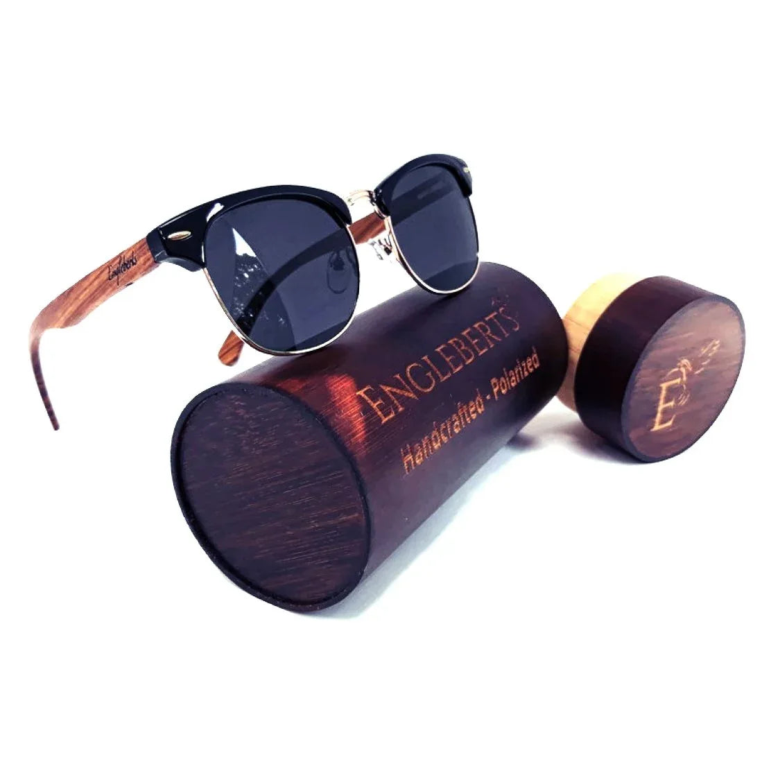 Real walnut wood club style sunglasses with polarized lenses placed next to bamboo case on white background.