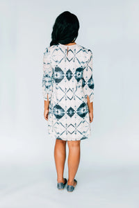 Back view of model in Inkwell Dress showing keyhole button closure and flowing fabric.
