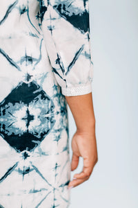 Close-up of Inkwell Dress fabric showcasing bold tie dye and polka dot details.
