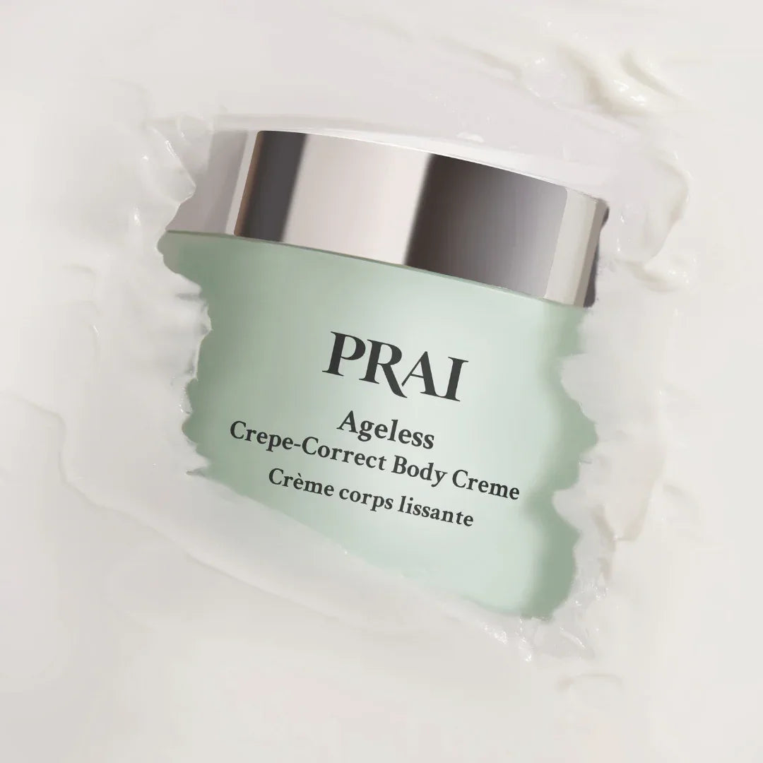 Close-up of Ageless Crepe-Correct Body Creme tube showing creamy texture and branding