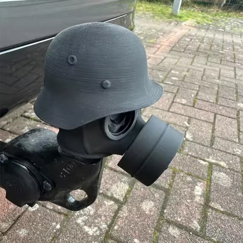 3D - printed trailer hitch cover with steel helmet and gas mask design. Protects the receiver tube from rusting.