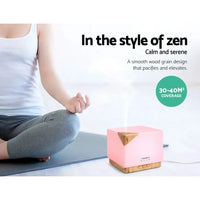 DEVANTi Aroma Diffuser placed on wooden table with ambient lighting