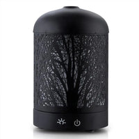 Side view of black aromatic diffuser showing iron art style design with mist coming out.