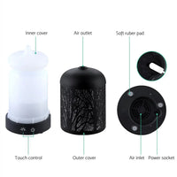 Black aroma diffuser illuminated as LED night light in dim room setting.