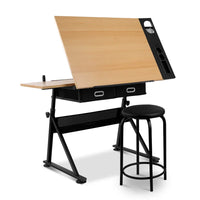 Tilt drafting table with natural wooden top and black metal frame, shown with adjustable stool beside it.