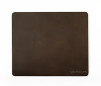 Top-down view of dark brown leather mouse pad highlighting grain texture.