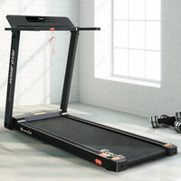 Treadmill in use inside home gym setting showing running belt and frame.