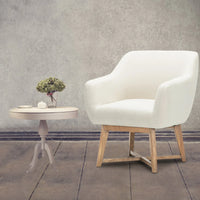 Beige tub lounge armchair angled to show its comfortable seat padding and fabric texture