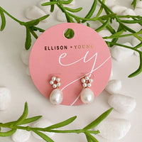 Model wearing Blooming Freshwater Pearl Drop Earrings, styled with casual clothing.