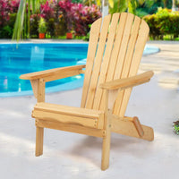 Wooden Adirondack chair outdoors near a small round table with drink glasses on top.