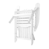 Folded white wooden Adirondack chair leaning against outdoor wall.