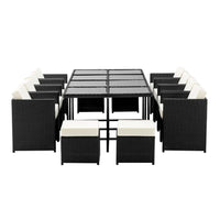 Side angle of the outdoor wicker dining set with chairs arranged around the table on stone tiles.