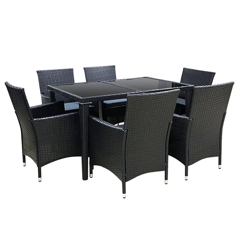 Seven-piece outdoor dining set with black rattan chairs and glass-top table on patio