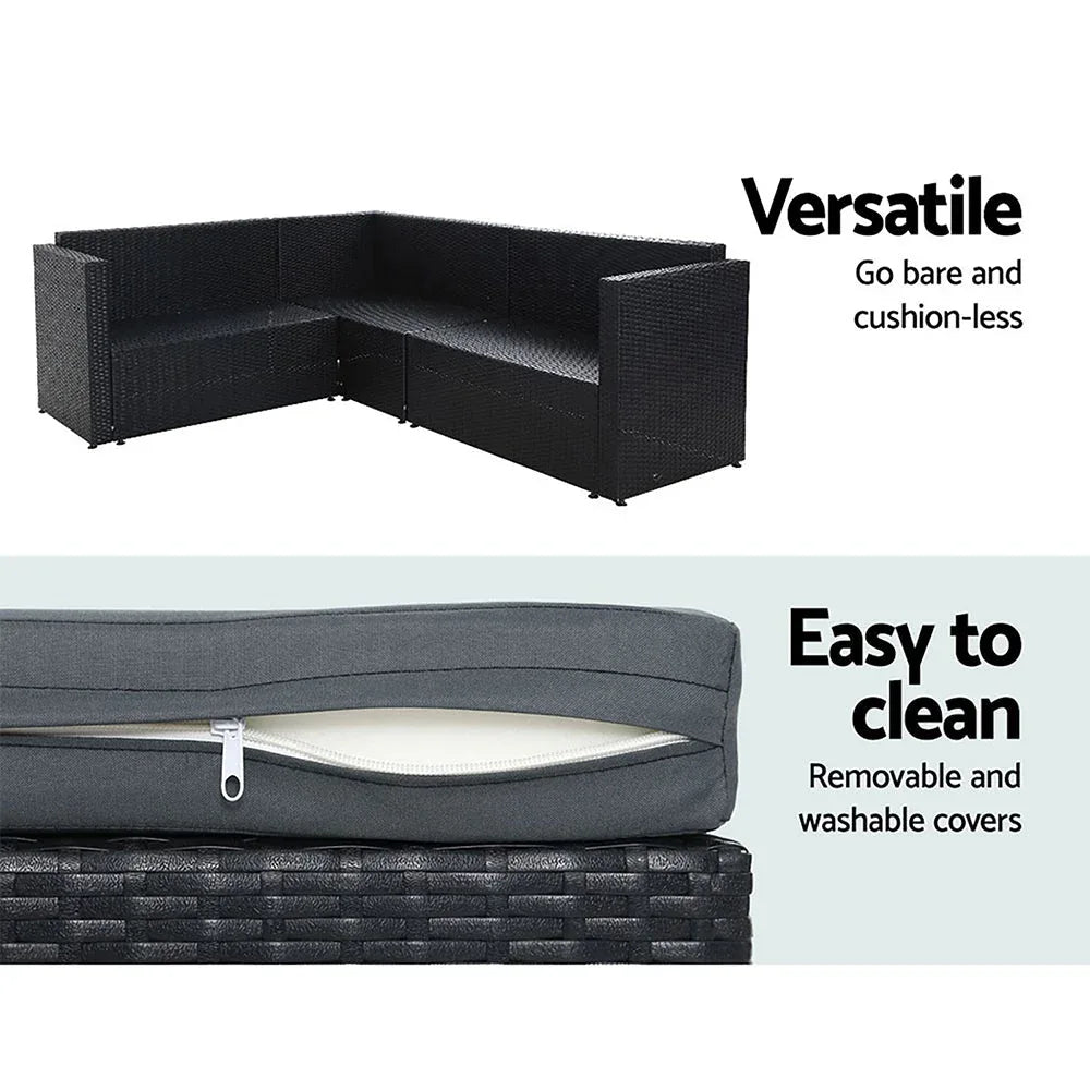 Top view of spacious black rattan patio furniture set with thick seat cushions outdoors.