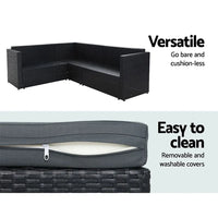 Top view of spacious black rattan patio furniture set with thick seat cushions outdoors.