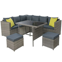 Gardeon outdoor patio sofa set with double seat and ottoman in dark wicker on stone patio.