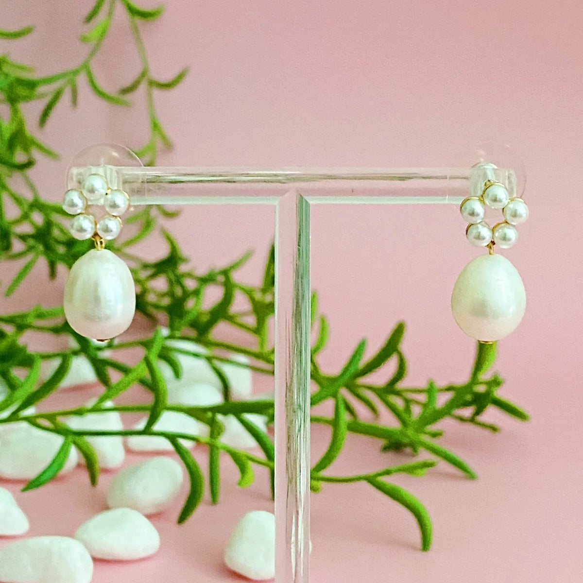 Pair of pearl drop earrings with circular bead clusters, arranged symmetrically for a graceful, stylish look.