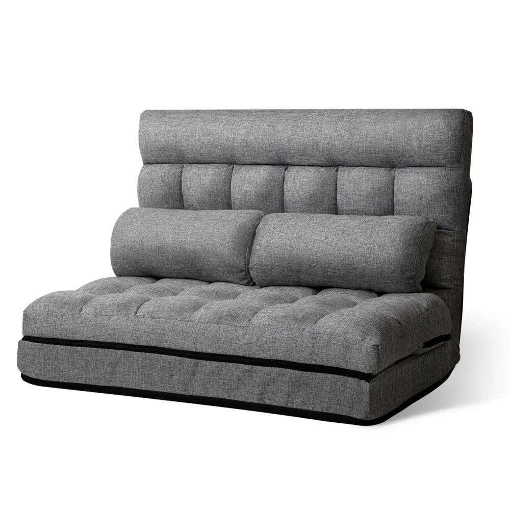 Folded grey Artiss lounge sofa bed placed on floor showing fabric texture and compact design.