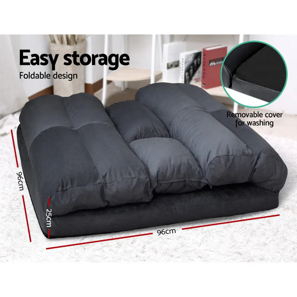 User reclining on Artiss Lounge Sofa Bed with a book in a cozy setting.