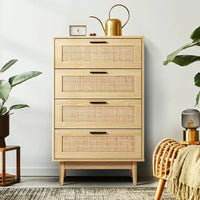 Rattan tallboy cabinet shown with drawers partially opened to reveal interior organization.