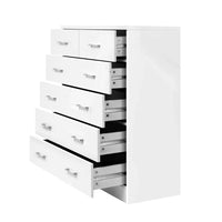 Top drawer of tallboy dresser partially open to show smooth sliding mechanism.