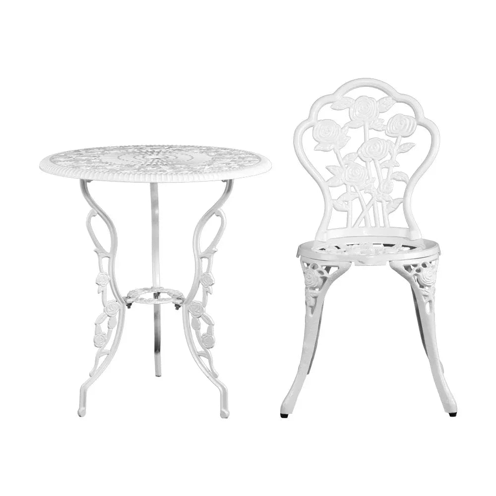Top view of white round aluminium table showing floral patterns and metalwork details.