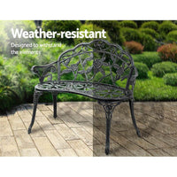Green Victorian bench with sturdy cast iron legs setup in outdoor garden space.