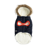 Close-up of navy parka's water repellent fabric and contrast pocket tabs on dog model.
