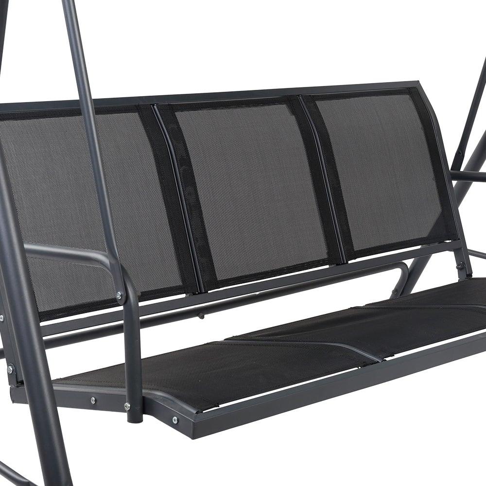 Relaxed person sitting on three-seater swing chair under the canopy in backyard