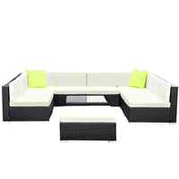 Top-down view of outdoor wicker patio lounge set with cushions and table