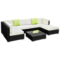 7-piece outdoor wicker sofa set with cushions arranged on patio by pool under blue sky.