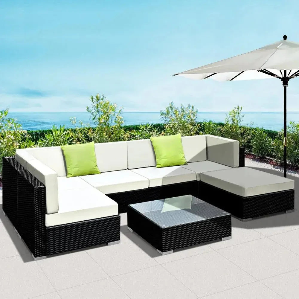 Detailed view of wicker weaving and aluminium frame beneath cushions on outdoor sofa.