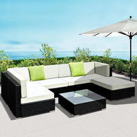 Detailed view of wicker weaving and aluminium frame beneath cushions on outdoor sofa.