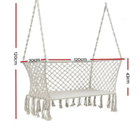 Close-up of the cream fabric and woven tassels on a double hammock chair.