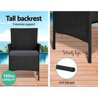 Black storage cover layered over Gardeon rattan outdoor lounge furniture for protection.
