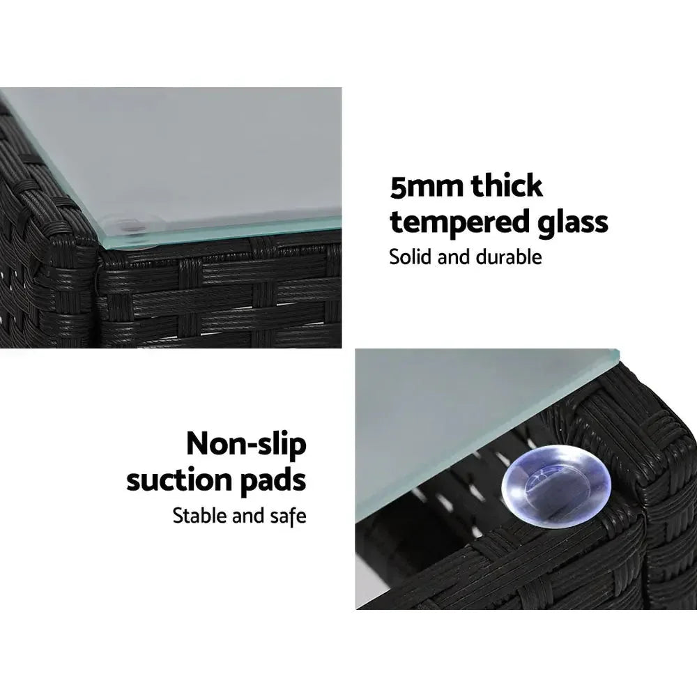 Gardeon outdoor lounge setting shielded by fitted black cover in garden setting.