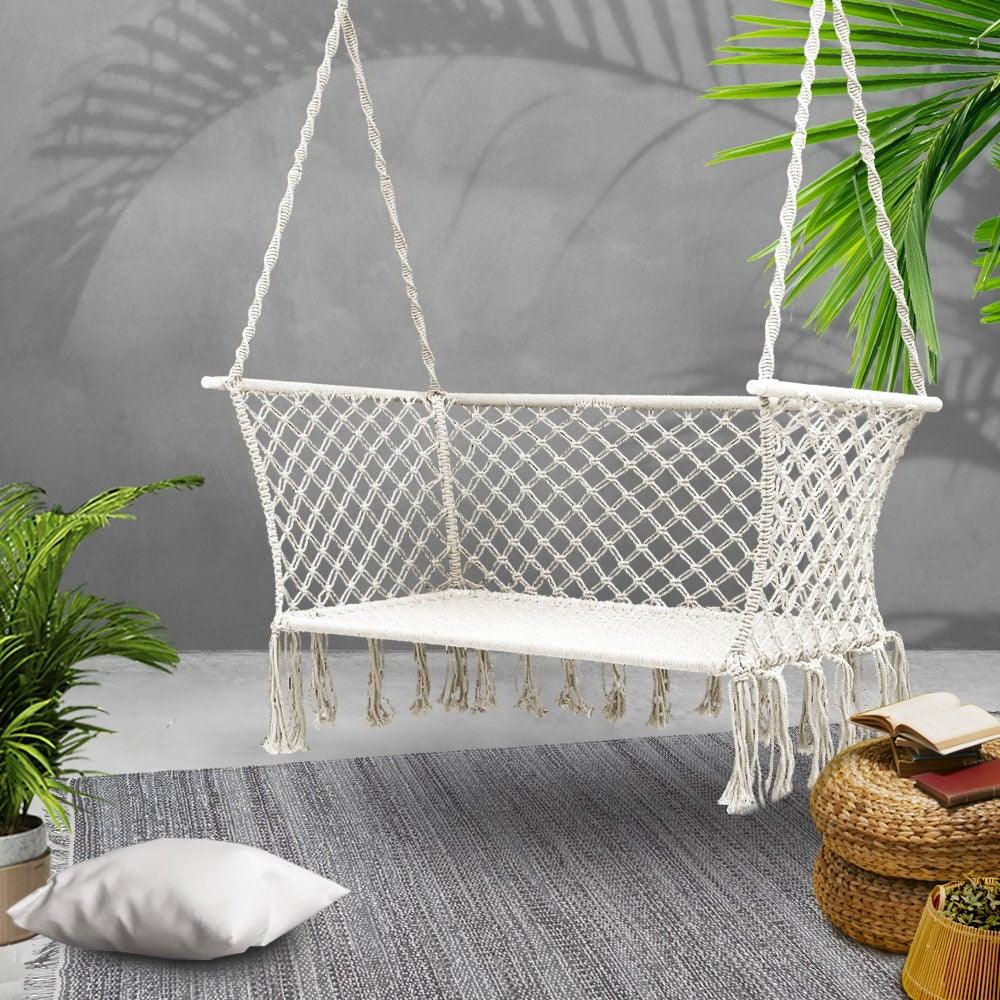 Close-up detail of the texture and tassels of a cream double hammock chair.