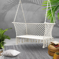 Close-up detail of the texture and tassels of a cream double hammock chair.
