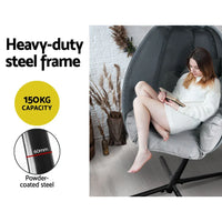 Outdoor egg hammock chair showing curved steel pole and foldable design.