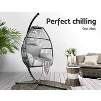 View of outdoor hanging chair’s sturdy steel frame supporting the hand-woven egg-shaped pod.