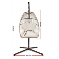 Side view of the egg-shaped hanging swing chair attached to a steel frame with rope.