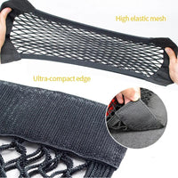 Rear view of car trunk showing black mesh organizer secured with elastic cords.