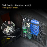 Car trunk organizer mesh net stretched inside vehicle storage area holding various objects.