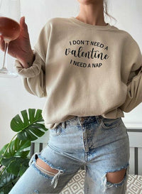 Close-up of black sweatshirt fabric and white text 'I Don't Need A Valentine.'